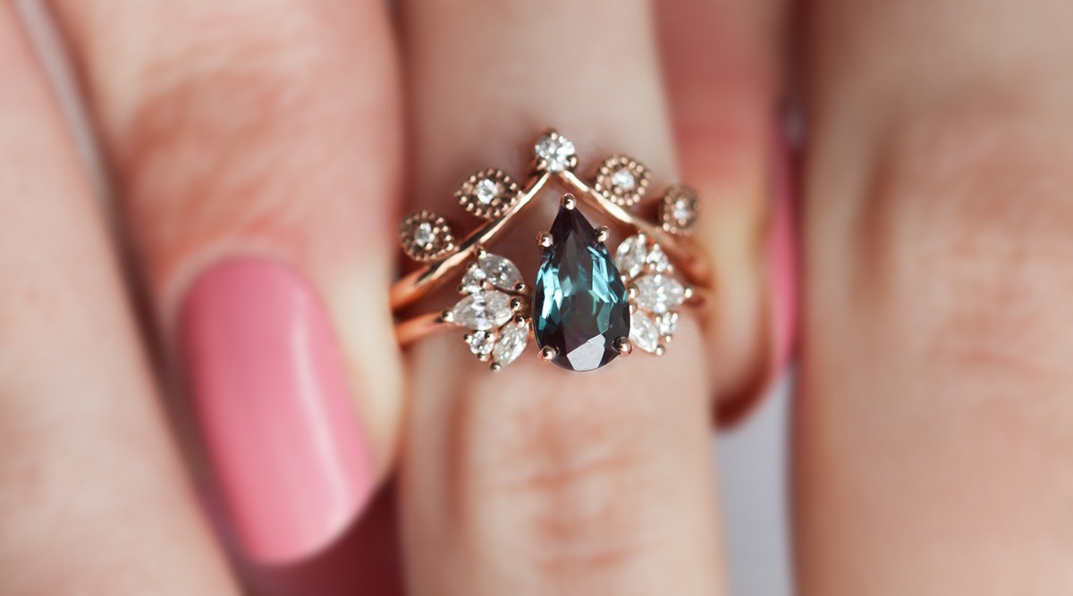 pear shaped shappre engagement ring with unique diamond band