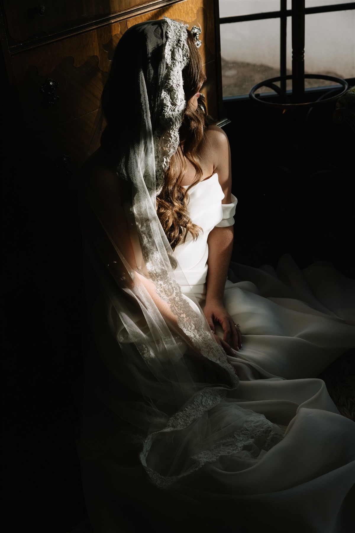lace-trimmed veil with off the shoulder wedding dress