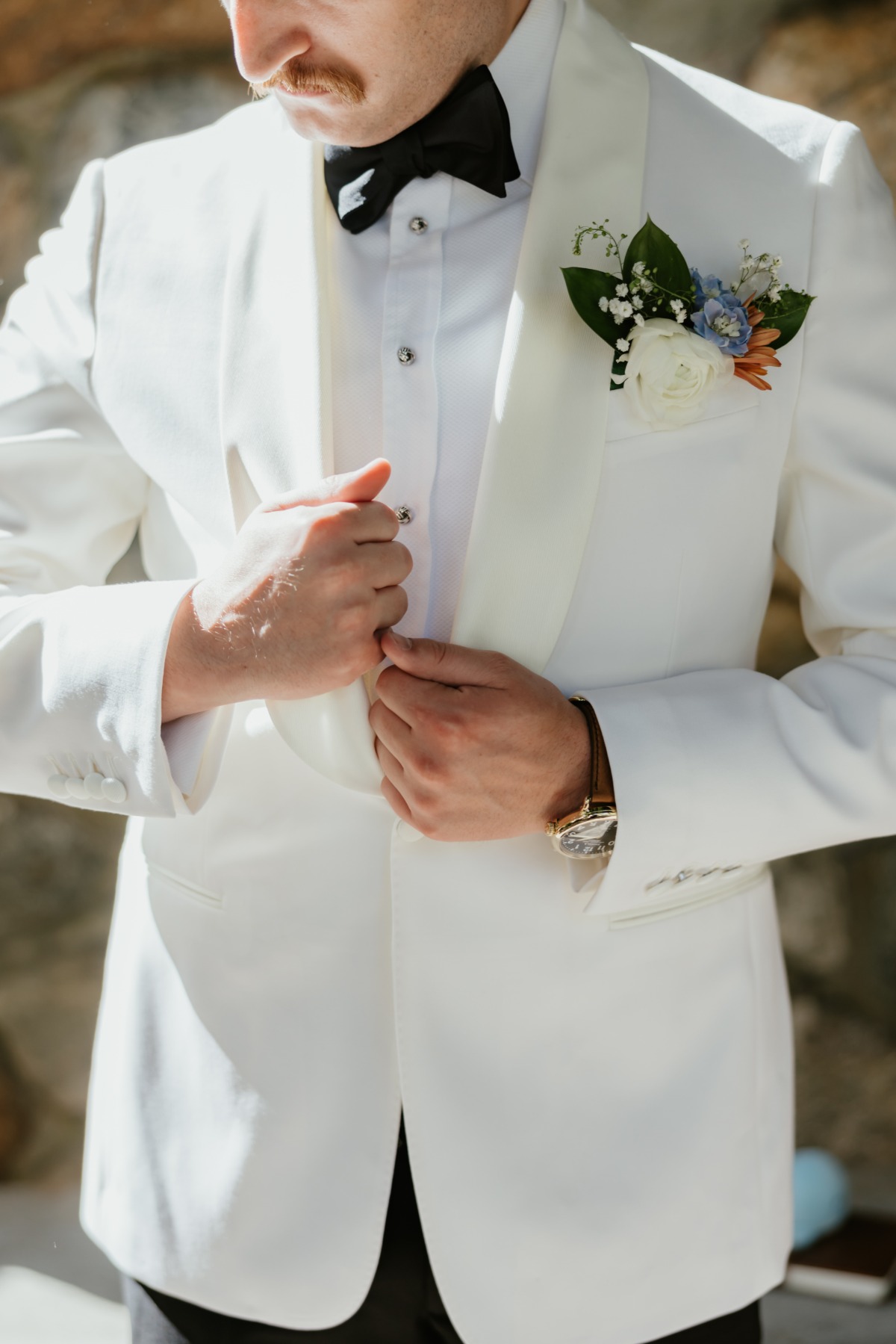 white dinner jacket for groom with boutonnière 
