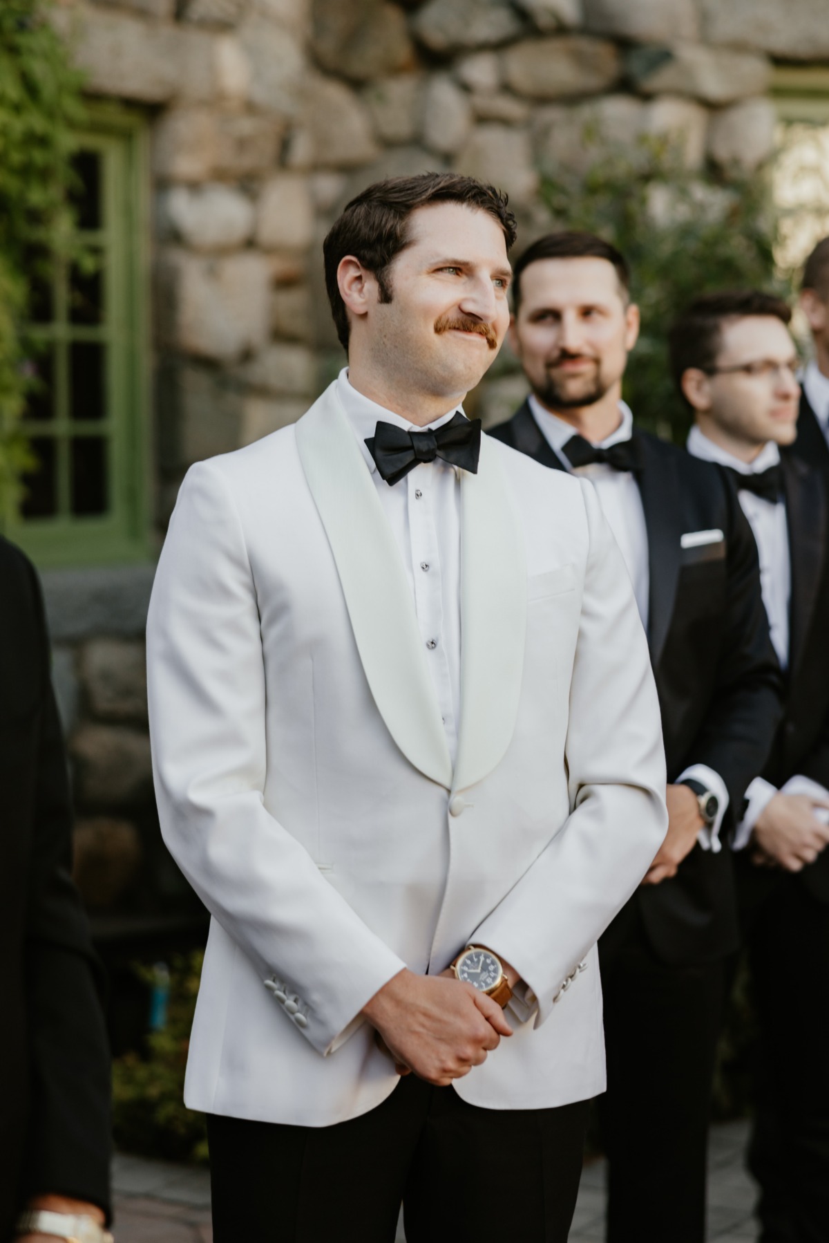 groom in white dinner jacket