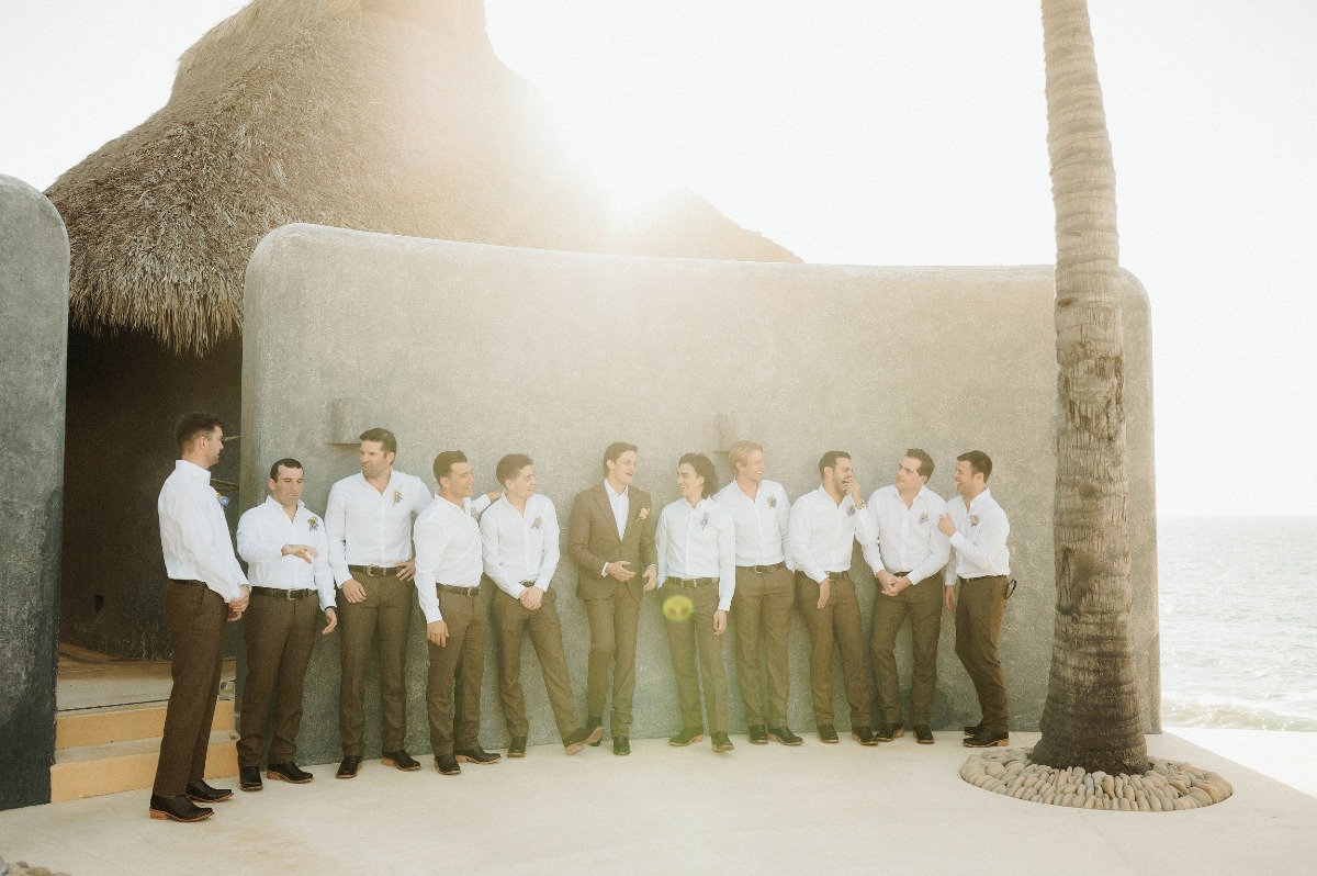 groomsmen in brown pants and white shirt