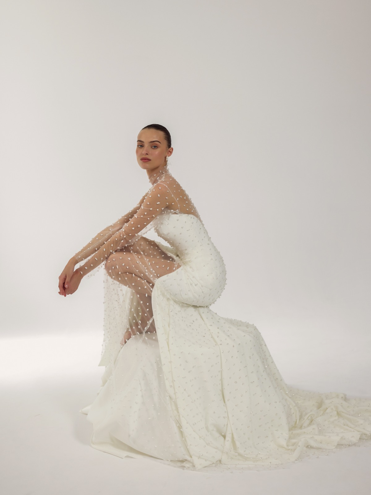 bride with sleek wedding dress and sheer cape
