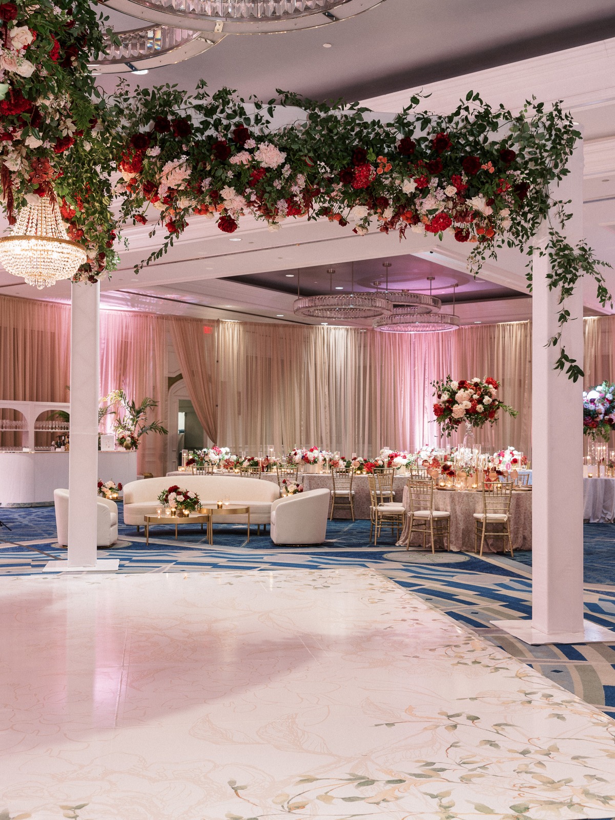 red rose and greenery wedding reception floral installation