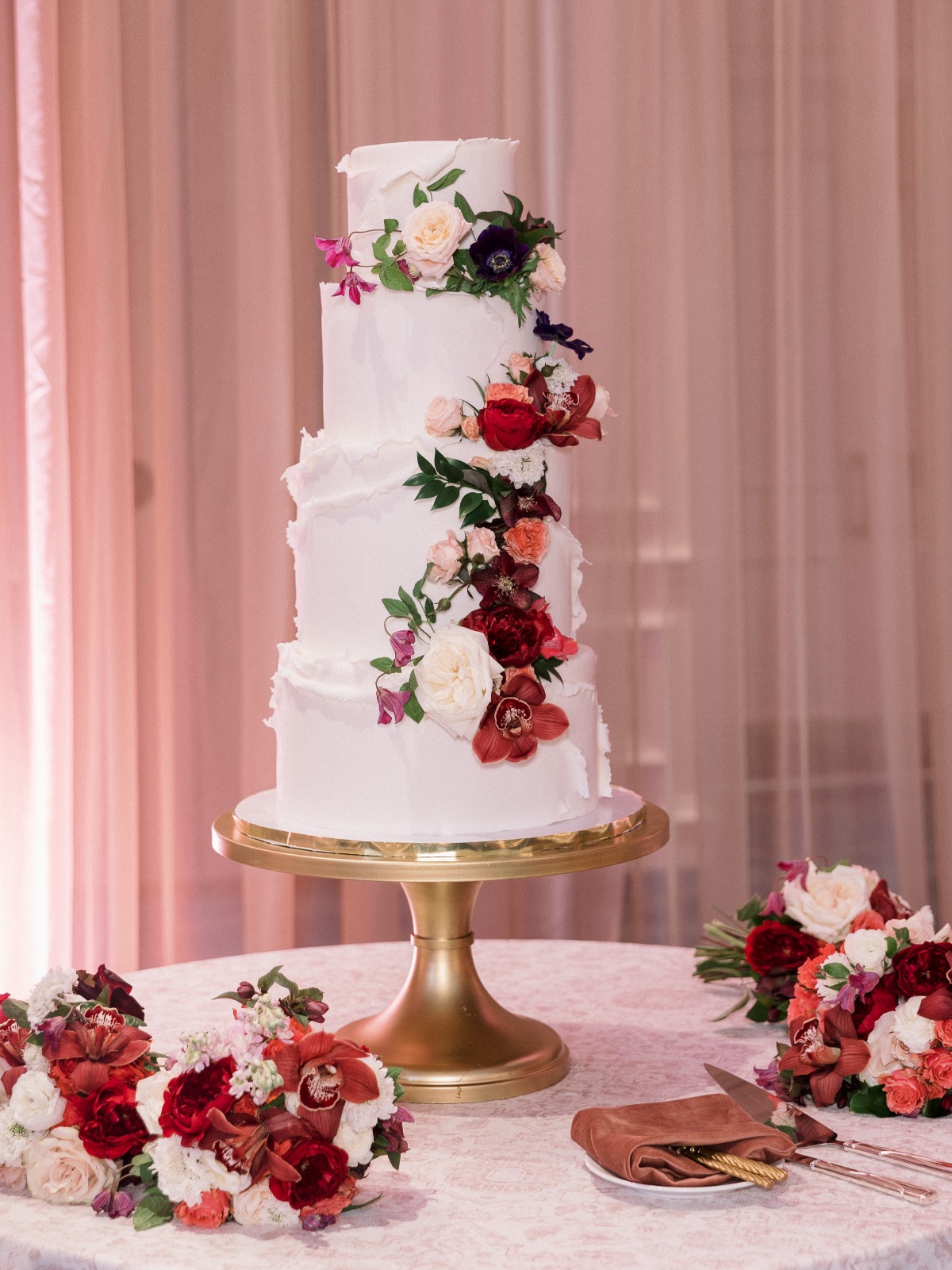 red rose and anemone accented wedding cake