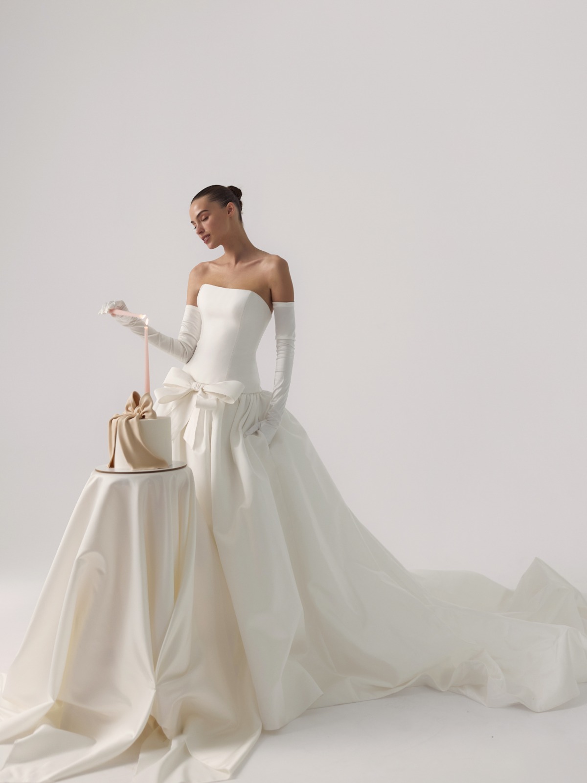 bride in ballgown with unique wedding cake