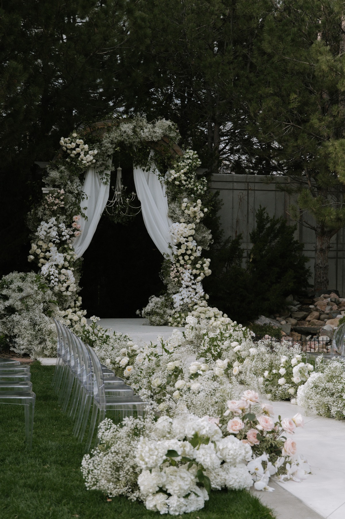white wedding ceremony with flower aisle