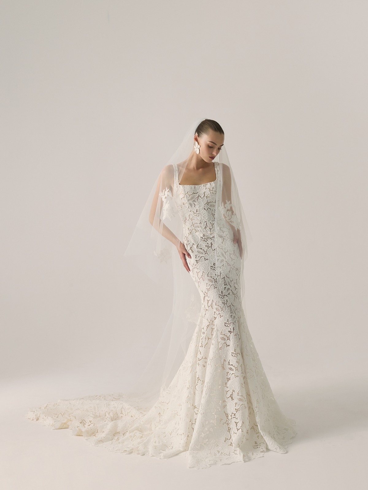 bride wearing lace wedding dress with long simple veil
