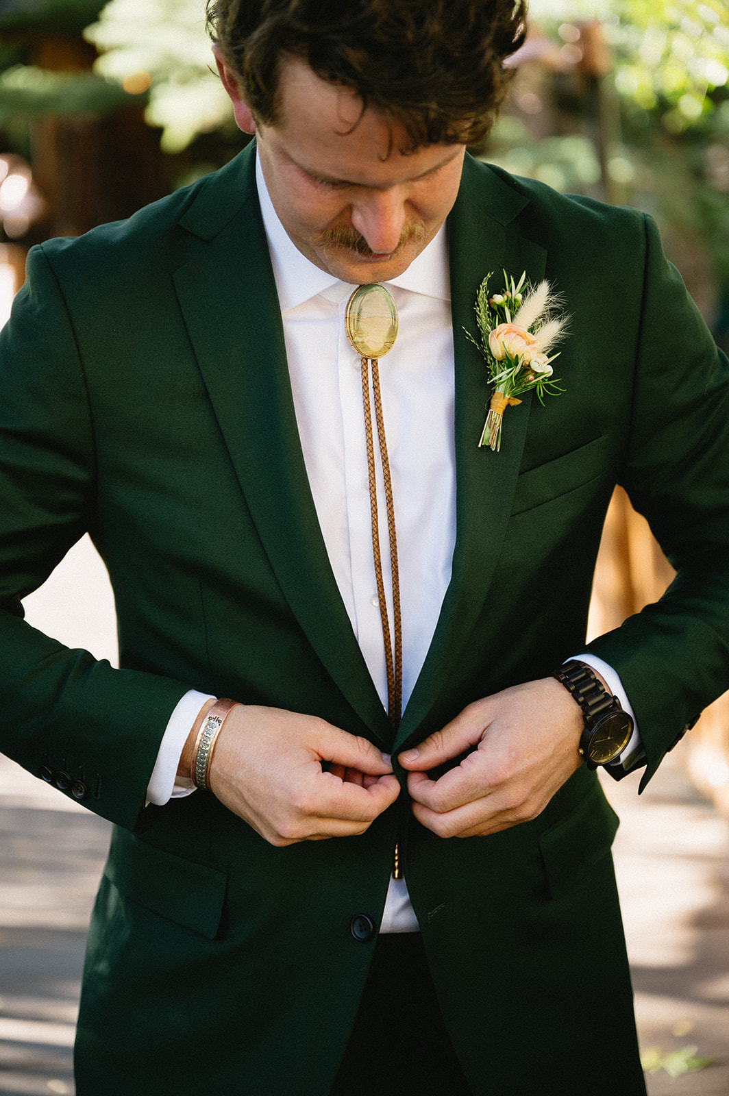 forest green suit with bolo tie