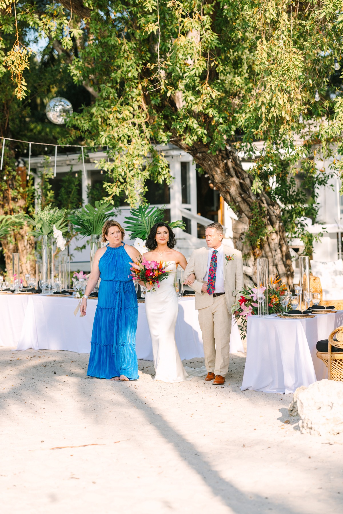 mom and dad walk bride down the aisle