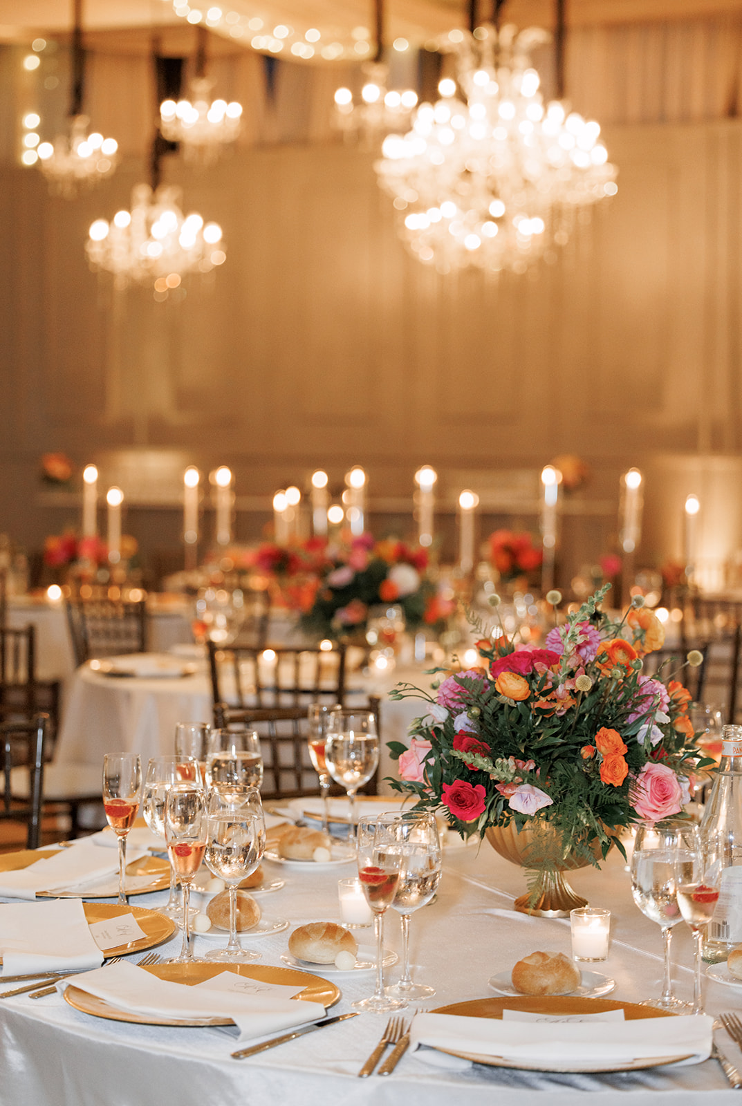 low gold vases with colorful centerpieces