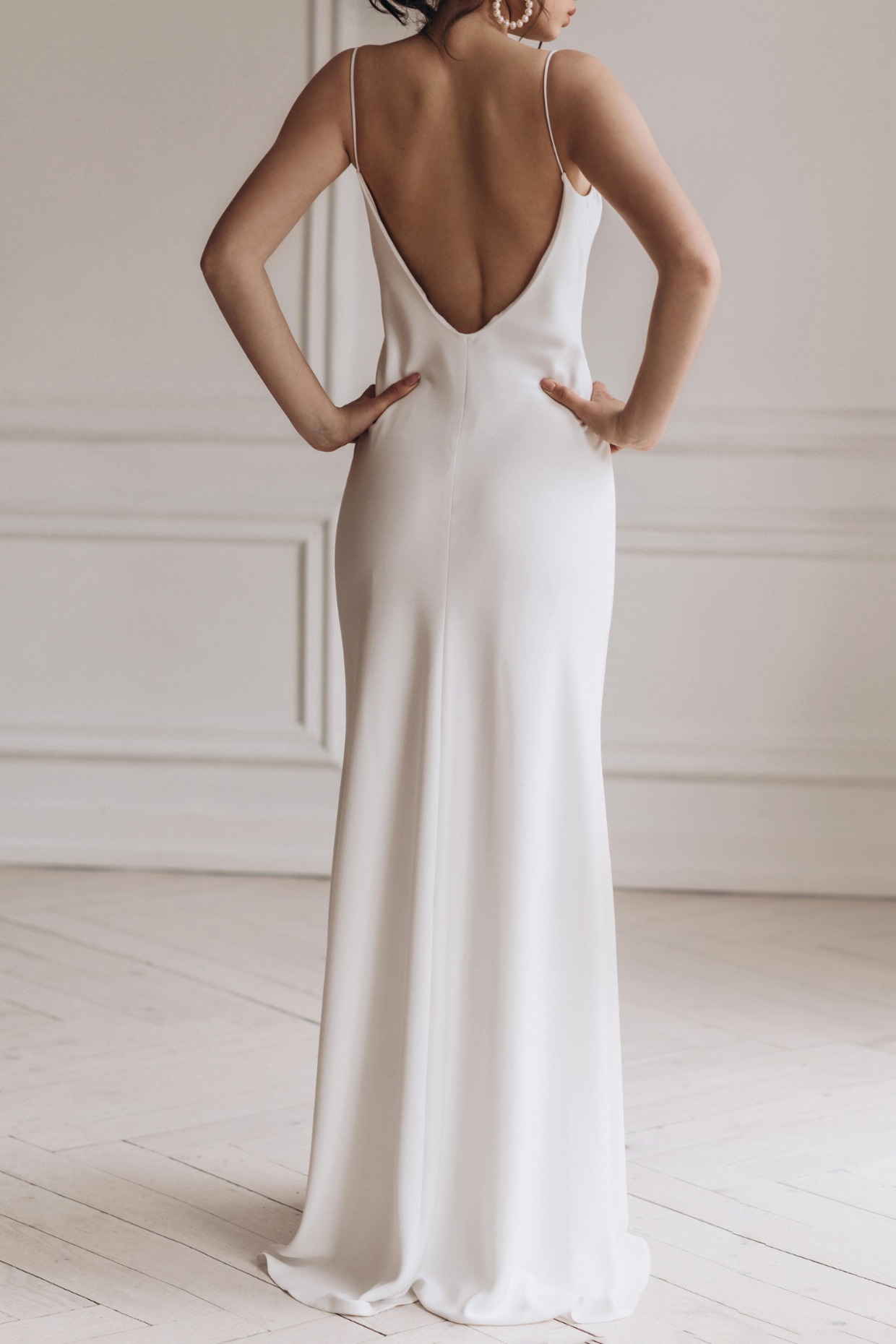 back view of a bride in a low back minimalistic wedding dress