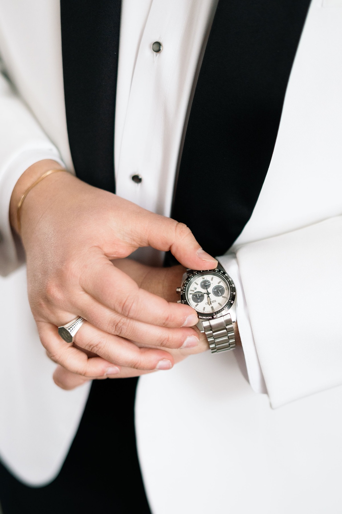 groom in white tuxedo