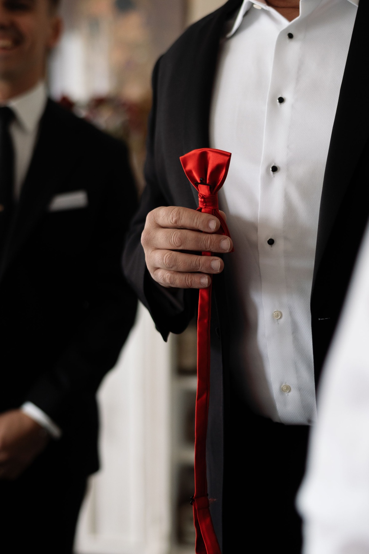 groomsmen with red bow ties