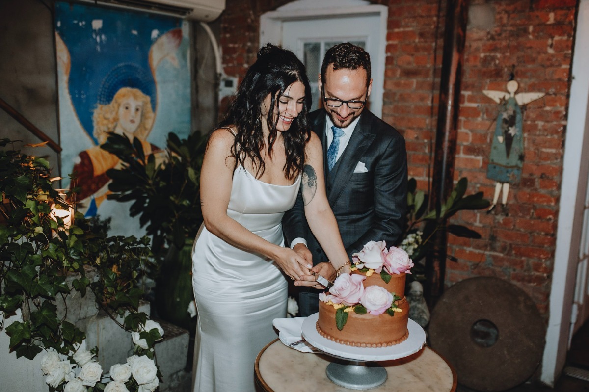 tan wedding cake with pink flowers