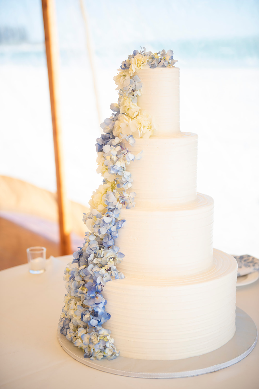 white wedding cake with blue and white flowers