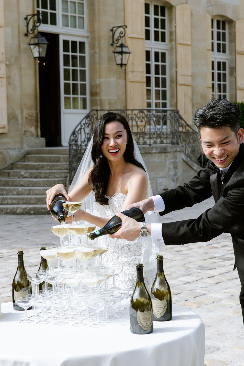 bride and groom pouring champagne tower