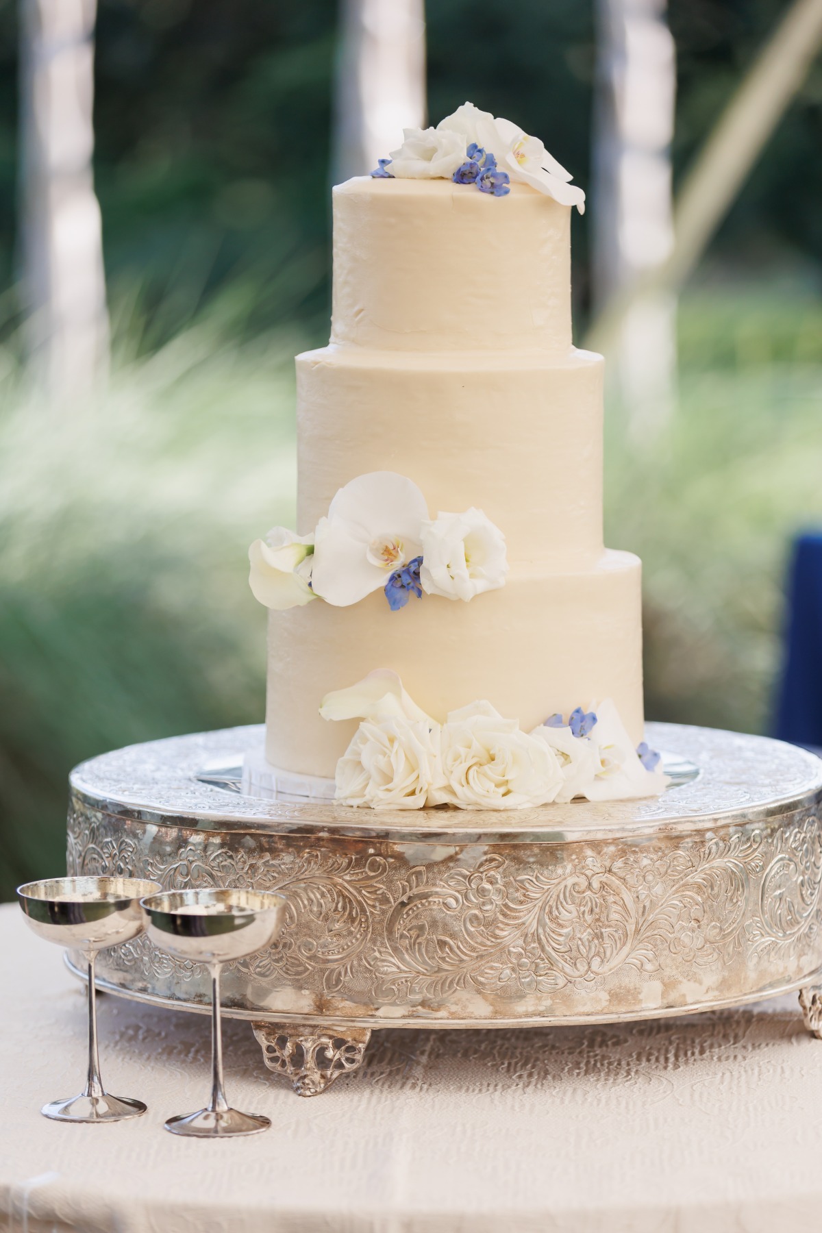 timeless buttercream wedding cake with fresh flowers