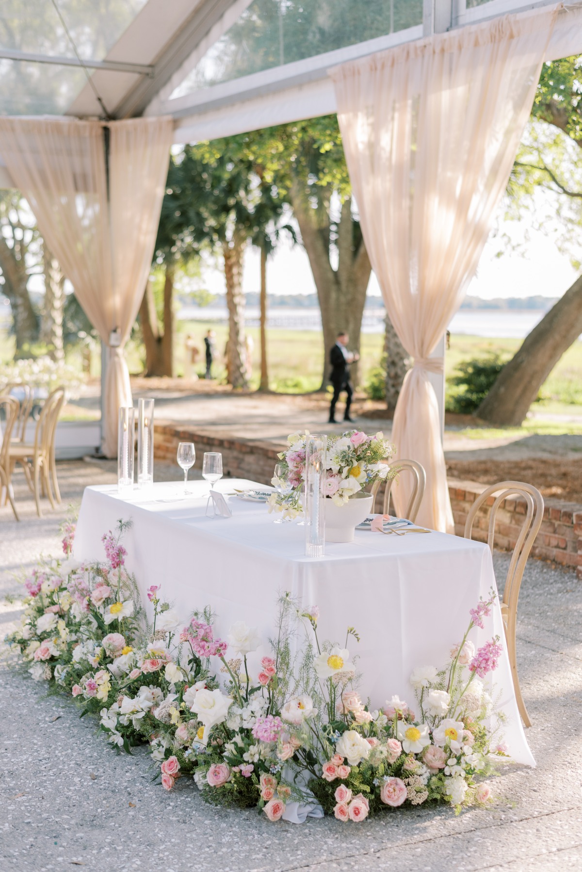sweetheart table with ground floral arrangements