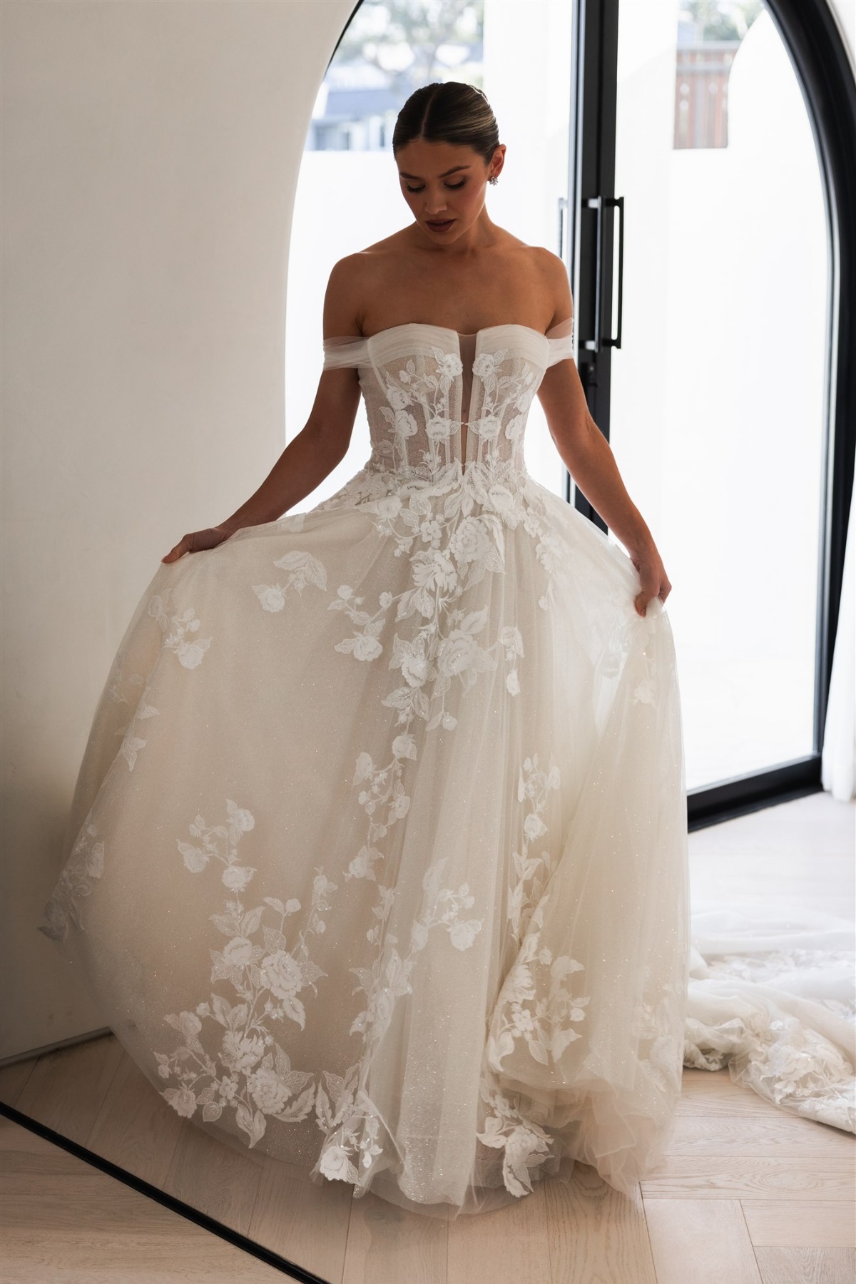 bride wearing off shoulder sheer tulle gown with lace florals