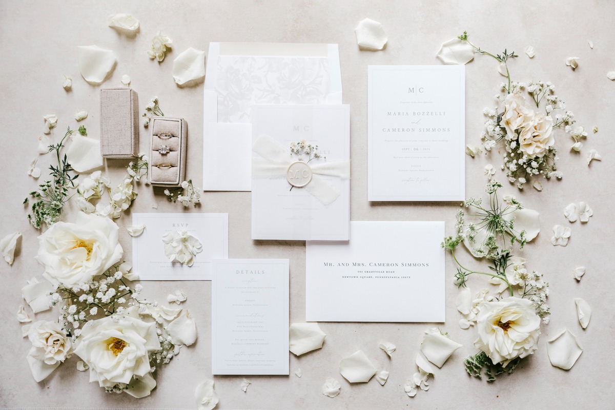 white wedding invitations with a custom wax seal and dried flower