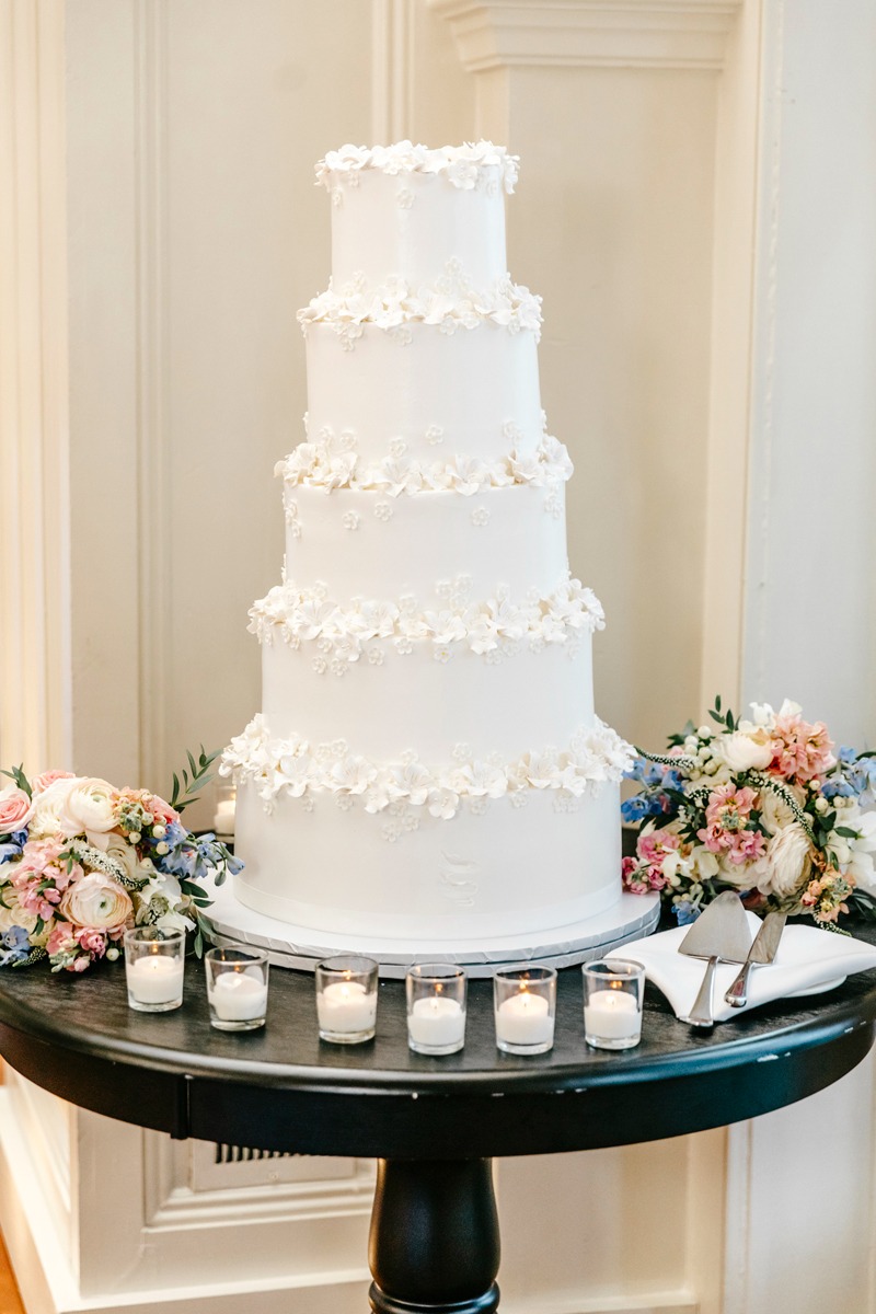 five tier white wedding cake with floral details