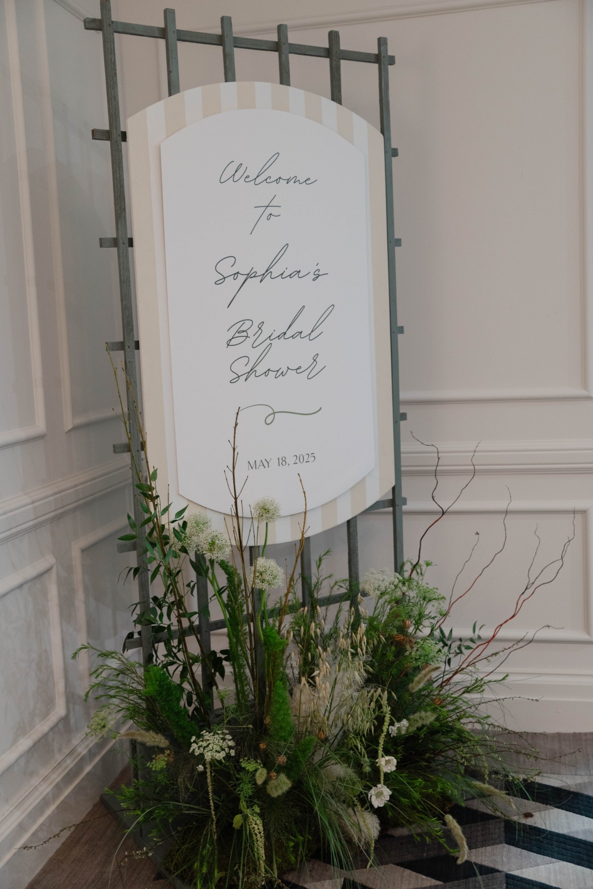 striped welcome sign with organic flowers