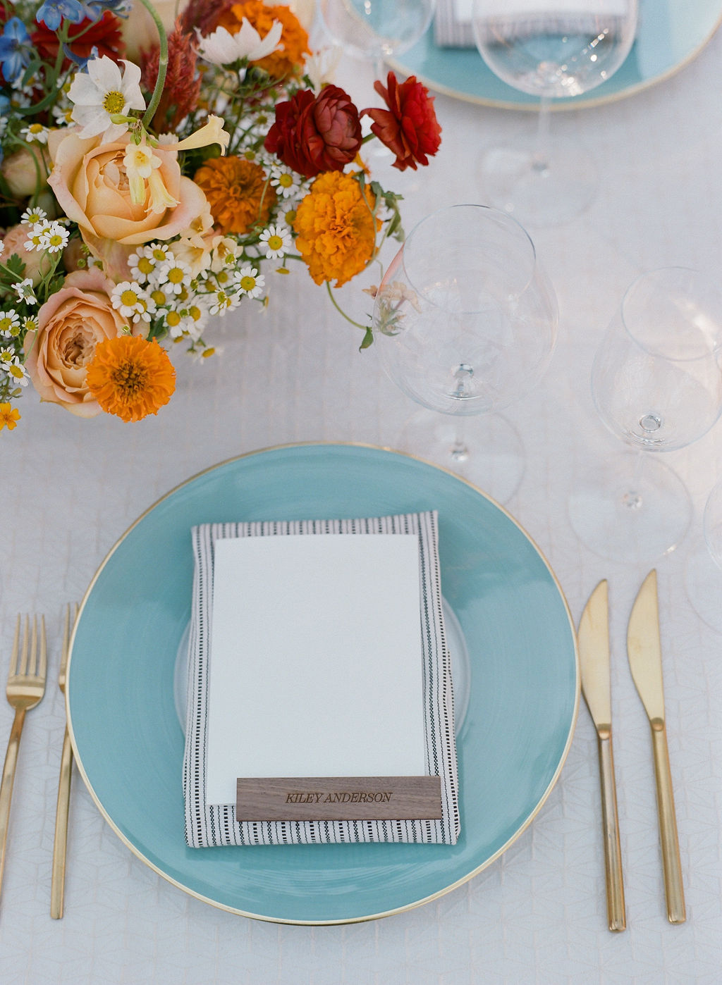 blue place settings with wood place cards