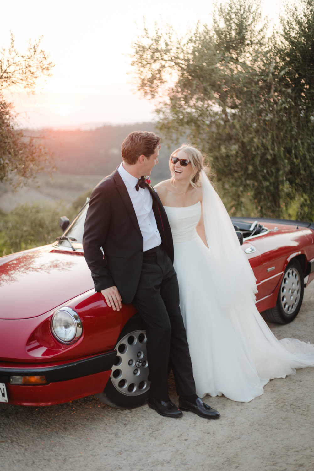 bride and groom with vintage convertible