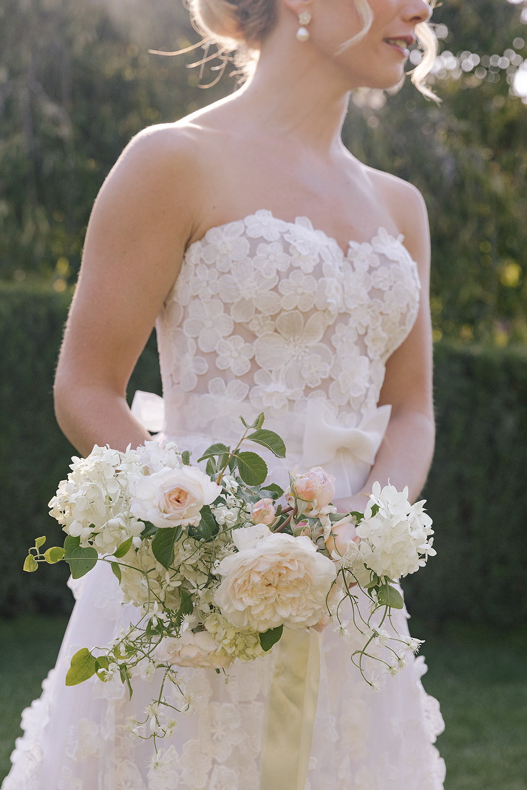floral applique wedding dress with bouquet with ivy