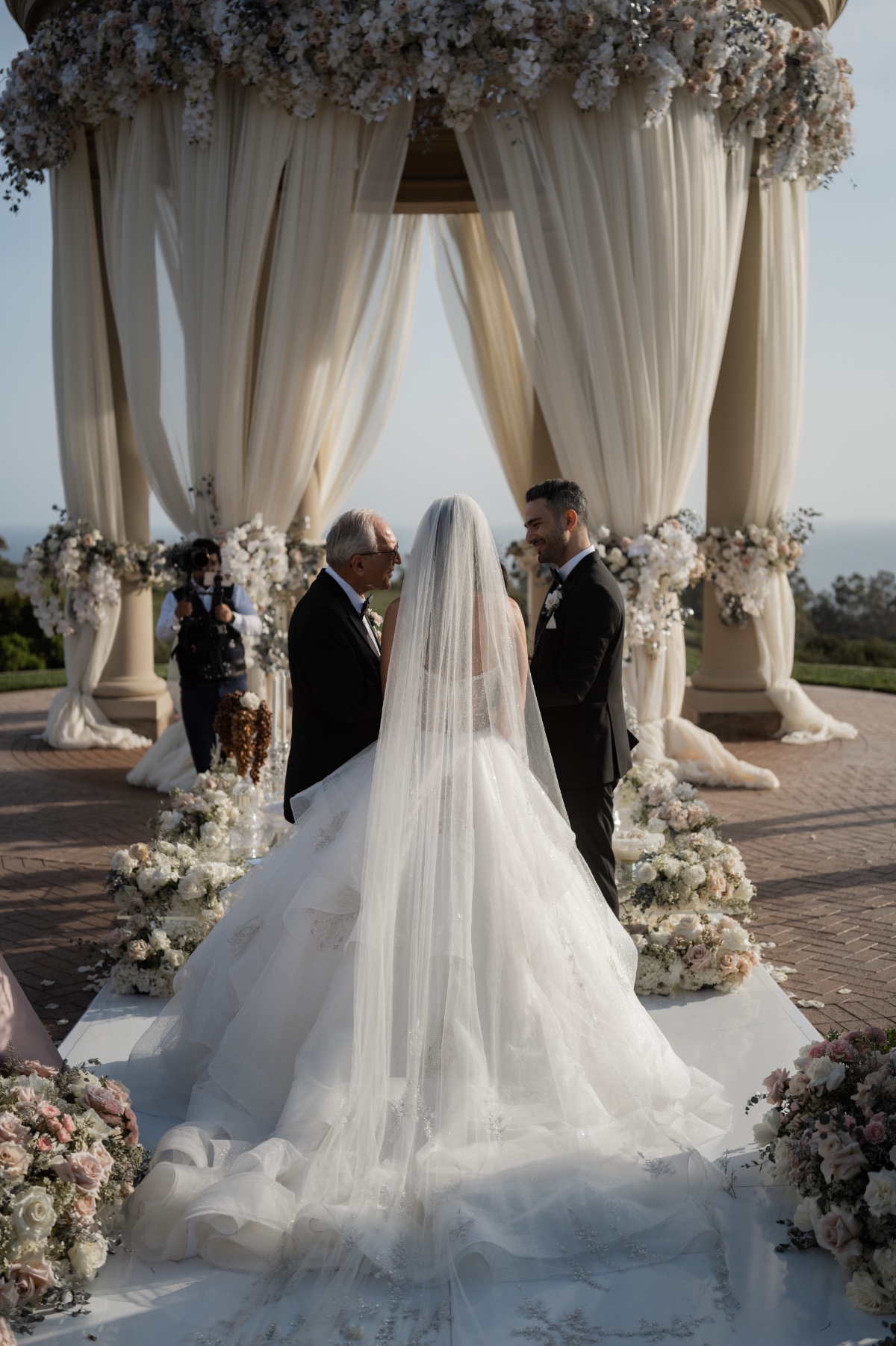 white and light pink lush wedding ceremony floral arrangements