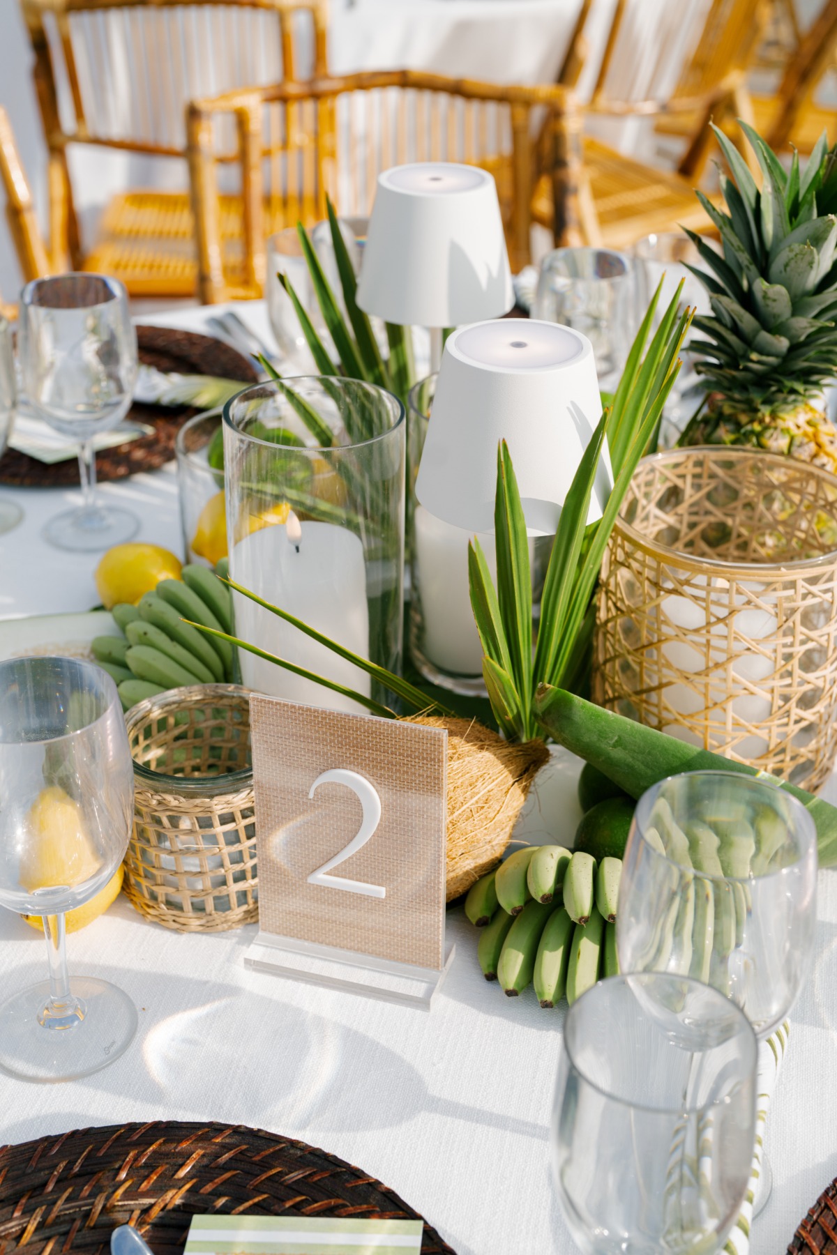tropical center piece for a wedding with lots of greenery, fruits and natural colors