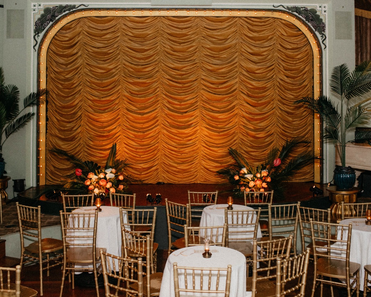 dark reception space with gold chairs