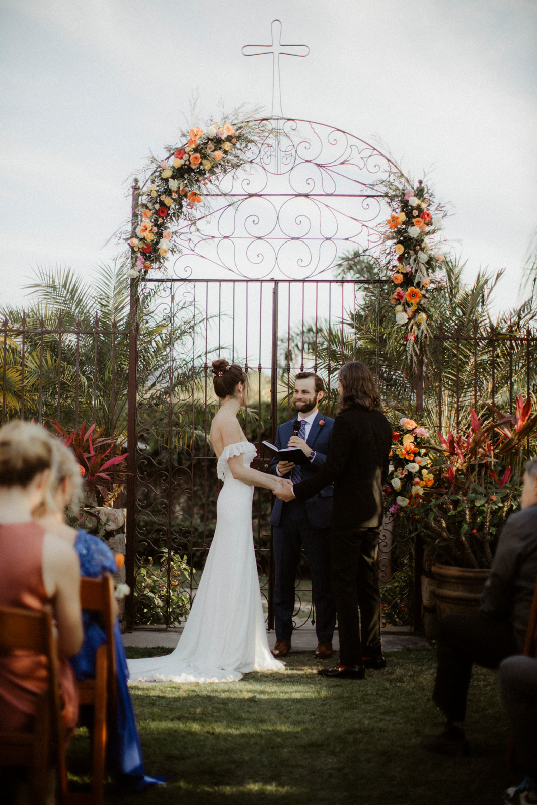 beachfront wedding ceremony in mexico with gate as backdrop