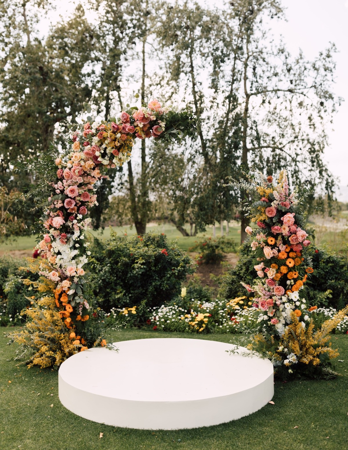pink and orange floral arch for wedding