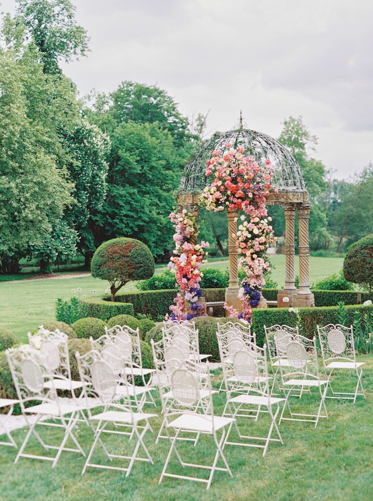 white metal chairs for garden wedding ceremony