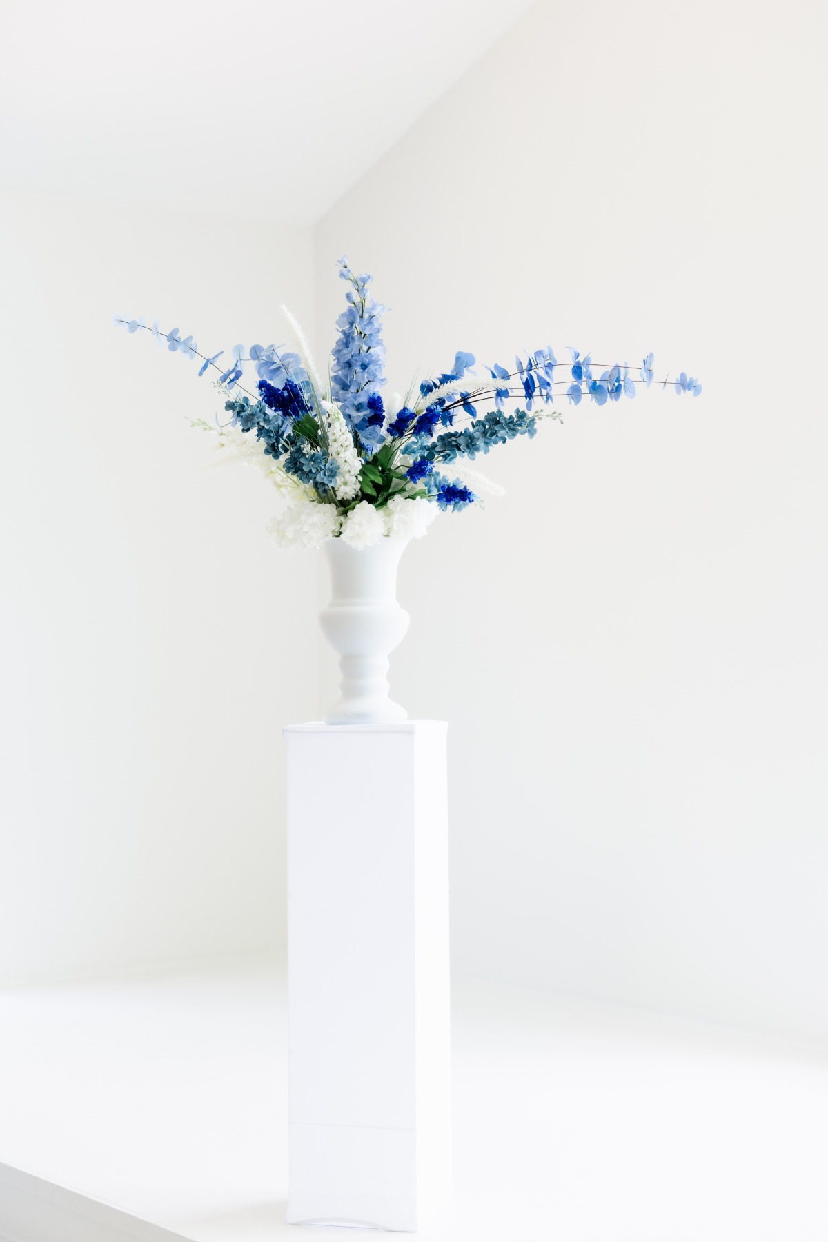 blue floral arrangements in white vases
