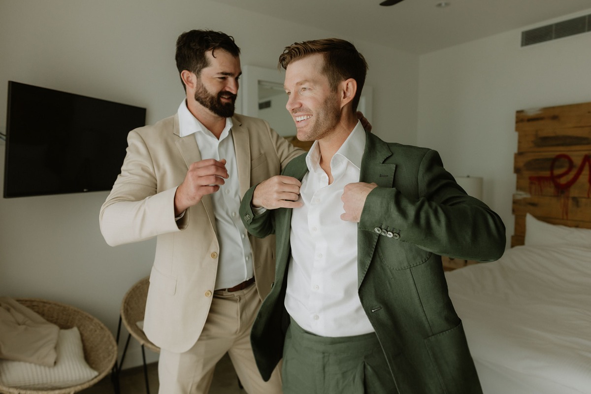 groom in green suit for wedding