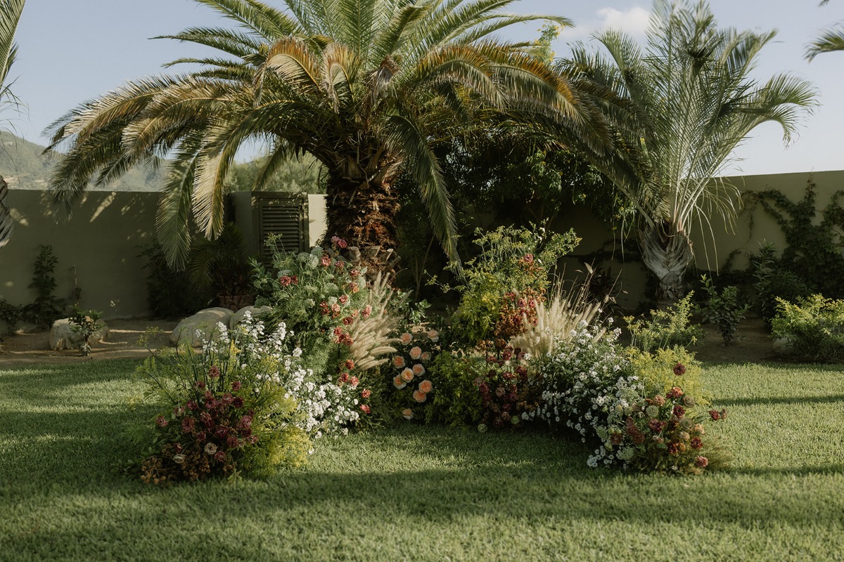 floor level organic looking florals for wedding ceremony
