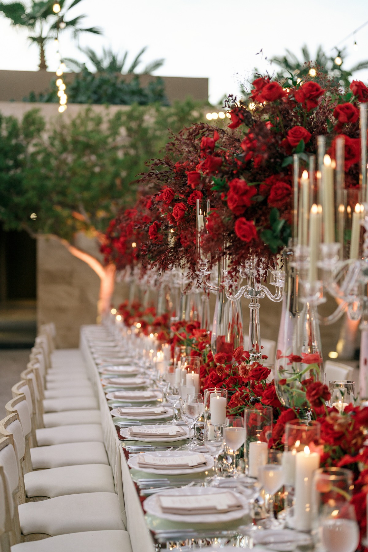 elegant outdoor wedding reception with red flowers