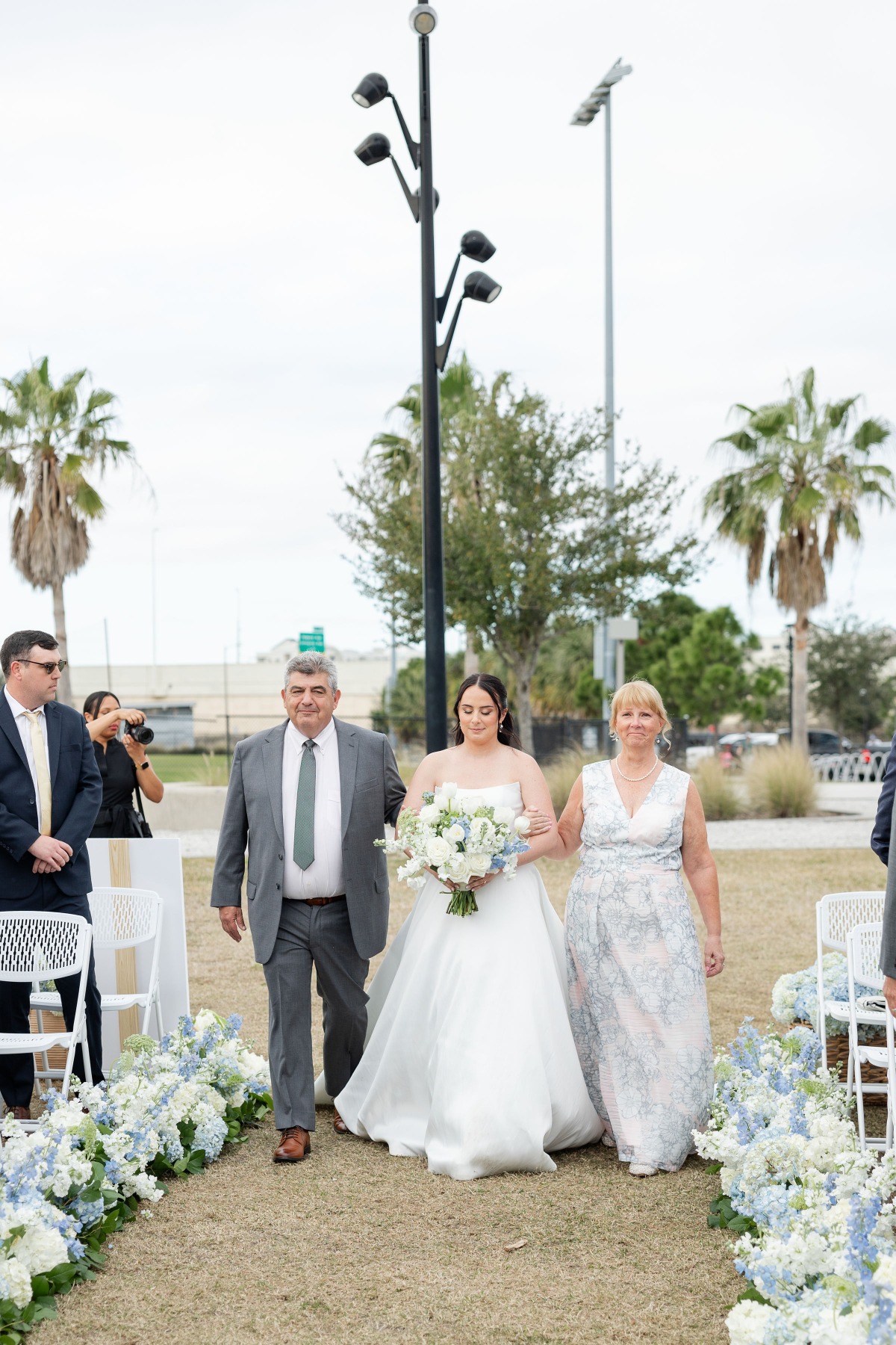 mom and dad walking bride down the aisle