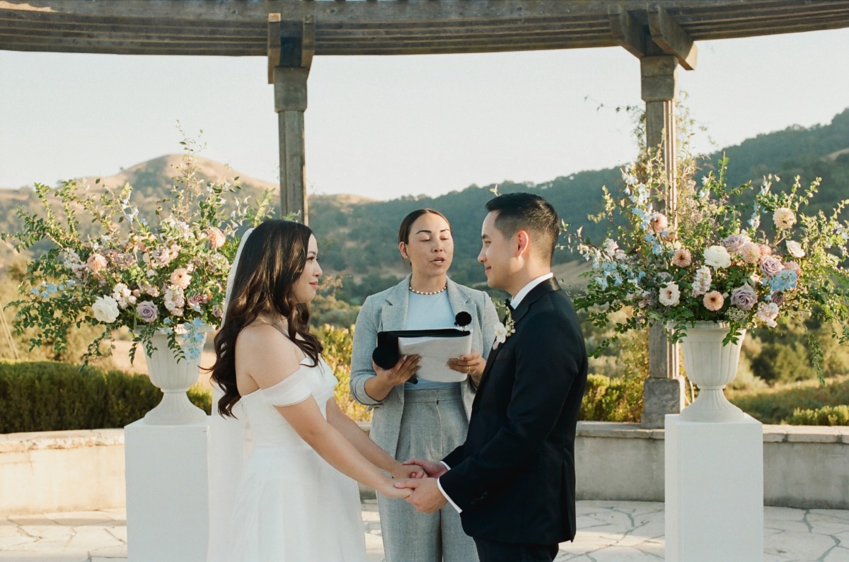 tall white pillars with white vase flower arrangements