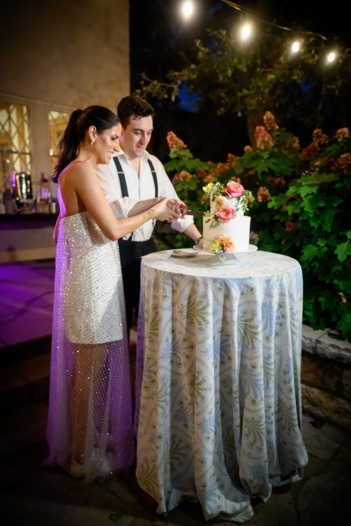 two tiered wedding cake with fresh flowers