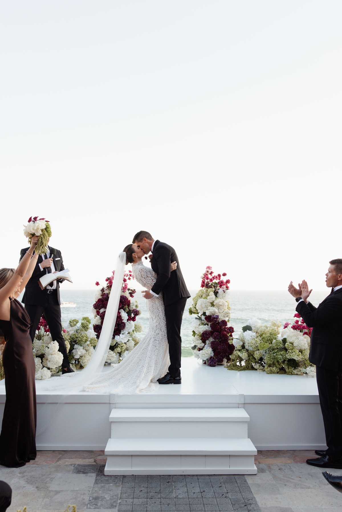 bride and groom kiss at cliffside ceremony