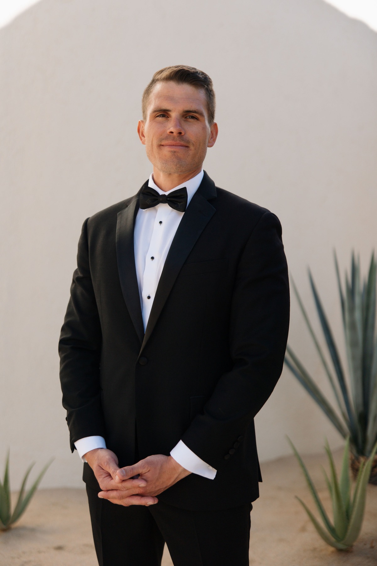 groom in black tux