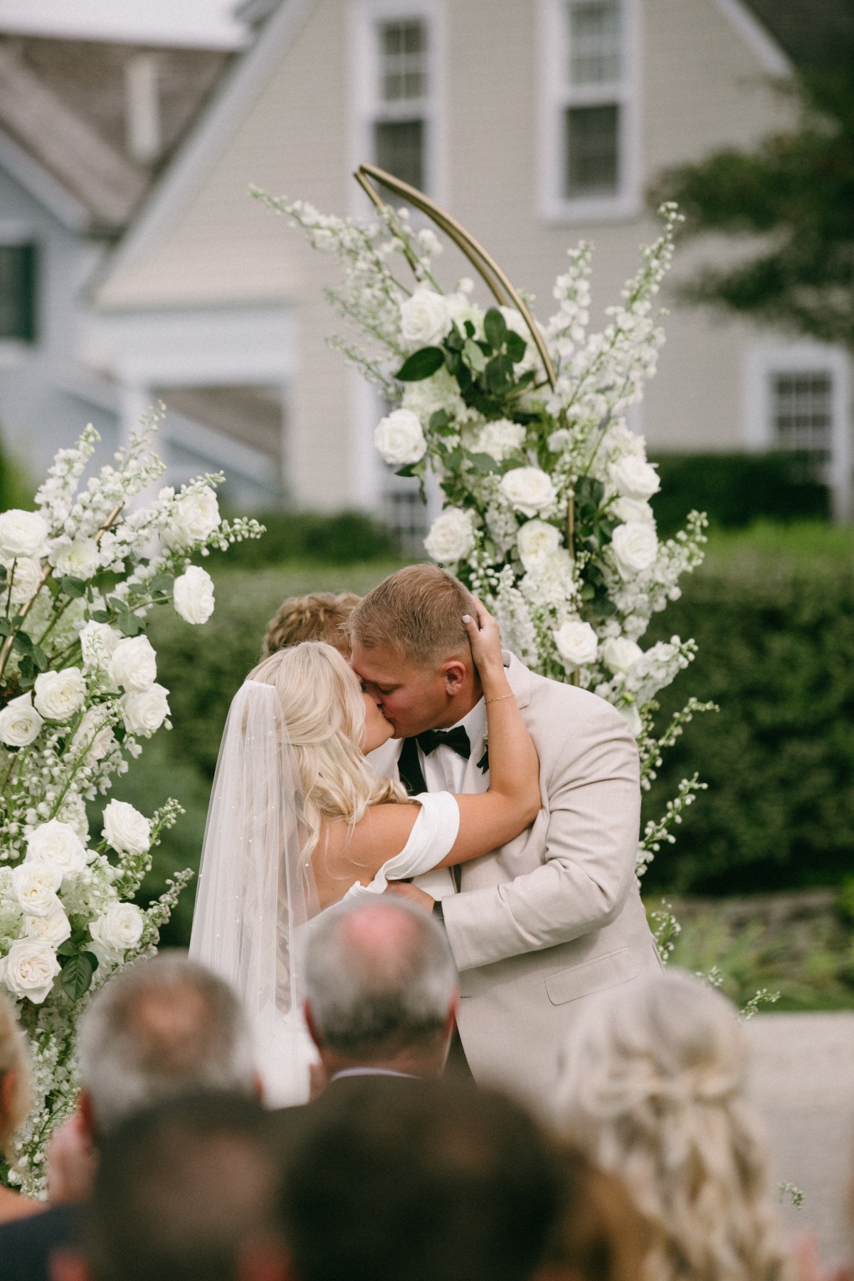 white asymmetrical floral arch for wedding