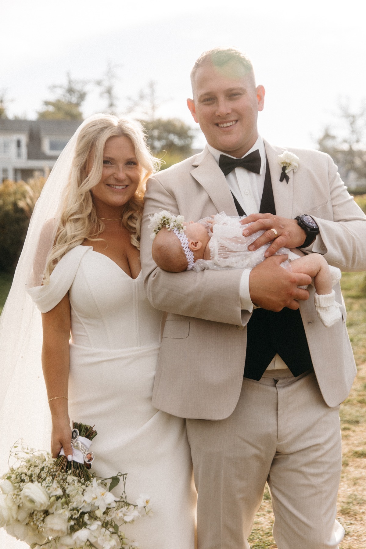 bride and groom with their baby