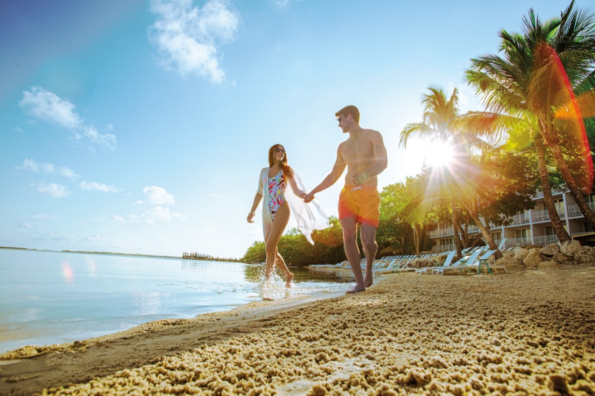 couple in swimsuits on beach