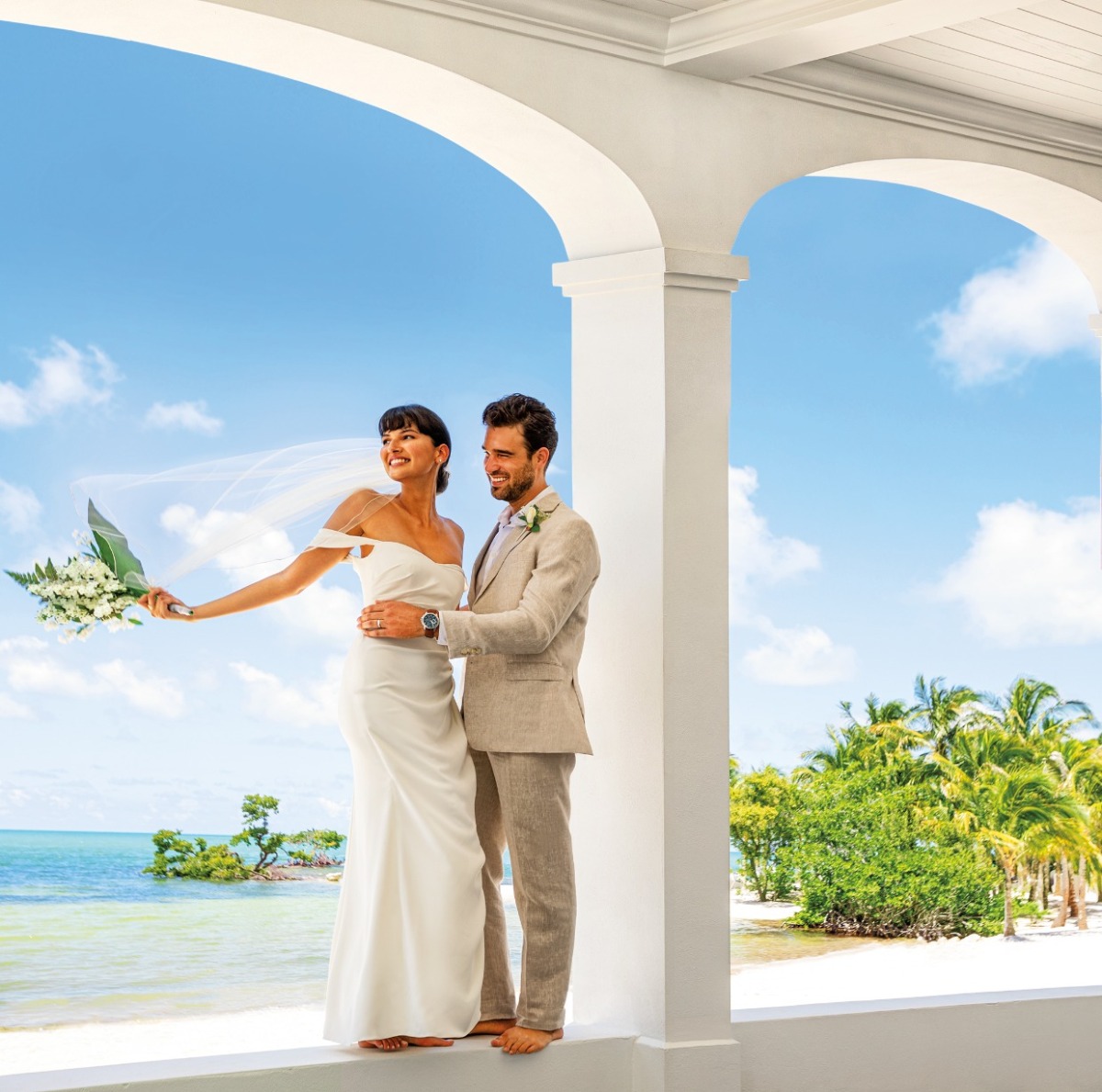 wedding couple in fancy venue overlooking ocean