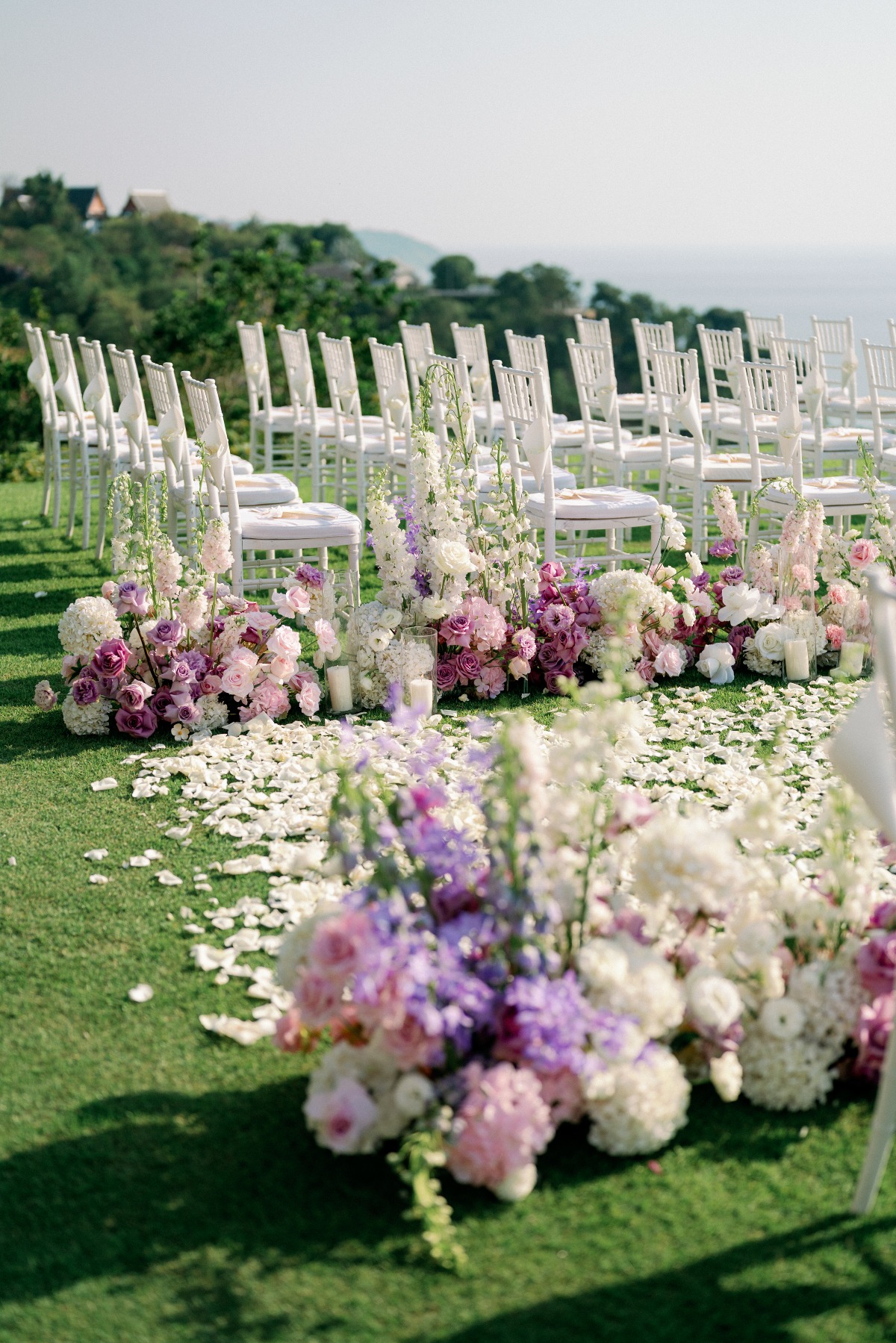 pastel purple pink and white wedding ceremony aisle floral arrangements