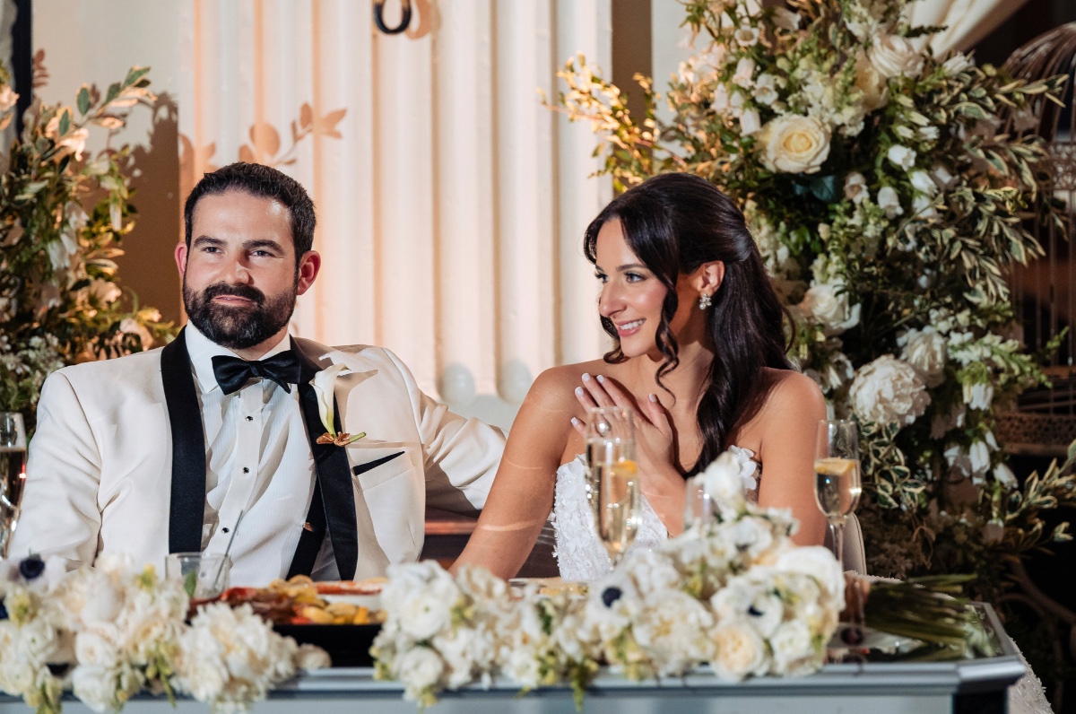 white and green sweetheart table floral installation